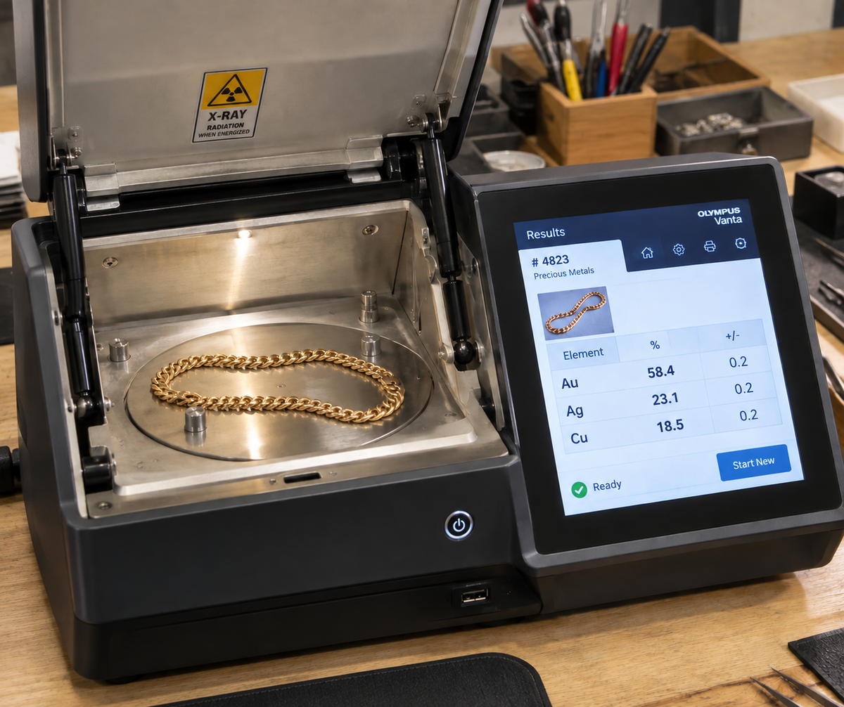 An XRF precious metal analyzer scanning gold jewelry to determine exact alloy purity at Studio Jewelers in the Bay Plaza Shopping Center.